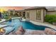 Resort-style pool and spa with rock waterfall feature and fire bowls for a relaxing backyard oasis at 37301 N 99Th St, Scottsdale, AZ 85262