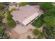 Aerial shot of a desert home with a covered patio and lush lawn surrounded by desert landscaping at 39241 N Boulder View Dr, Scottsdale, AZ 85262