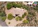 Overhead view showcases a spacious desert home surrounded by mature trees and natural landscaping at 39241 N Boulder View Dr, Scottsdale, AZ 85262
