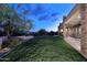 This backyard has a covered patio, lush lawn, mature landscaping, and relaxing views at 39241 N Boulder View Dr, Scottsdale, AZ 85262