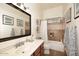 Bright bathroom featuring tile flooring, a large vanity with plenty of counter space and a shower and tub combination at 39241 N Boulder View Dr, Scottsdale, AZ 85262