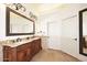 A bathroom features double sinks, granite countertops, and tile floors at 39241 N Boulder View Dr, Scottsdale, AZ 85262