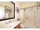 Functional bathroom with a shower-tub combo, a vanity, and a decorative mirror at 39241 N Boulder View Dr, Scottsdale, AZ 85262