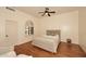 Comfortable bedroom with a full bed, hardwood floors, a unique window, and two chairs at 39241 N Boulder View Dr, Scottsdale, AZ 85262