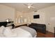 A spacious bedroom features a cozy seating area, bay windows with shutters, hardwood floors, and a ceiling fan at 39241 N Boulder View Dr, Scottsdale, AZ 85262