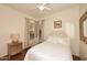 Cozy bedroom featuring neutral tones, hardwood floors, and natural light from a window at 39241 N Boulder View Dr, Scottsdale, AZ 85262