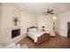 Bedroom features hardwood floors, a fireplace, a ceiling fan, and plenty of natural light at 39241 N Boulder View Dr, Scottsdale, AZ 85262