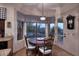 Bright breakfast nook features a wood table, chairs, chandelier and window with a view of the backyard at 39241 N Boulder View Dr, Scottsdale, AZ 85262