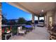 The covered patio has ample seating, stone columns, and offers great views of the backyard at 39241 N Boulder View Dr, Scottsdale, AZ 85262