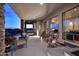 Inviting covered patio with comfortable seating, stone columns, and beautiful sunset views at 39241 N Boulder View Dr, Scottsdale, AZ 85262
