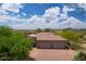 Expansive estate featuring a three-car garage, desert landscaping, and mountain views at 39241 N Boulder View Dr, Scottsdale, AZ 85262