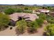 Estate aerial view displaying mature trees, desert landscaping, and a charming front entry at 39241 N Boulder View Dr, Scottsdale, AZ 85262