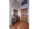 Inviting foyer boasts hardwood floors, an ornate console table, and decorative lighting at 39241 N Boulder View Dr, Scottsdale, AZ 85262