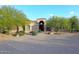 Elegant home featuring desert landscaping, mature trees, and a grand arched entryway at 39241 N Boulder View Dr, Scottsdale, AZ 85262