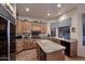 Traditional kitchen featuring wood cabinetry, granite countertops, a kitchen island, and modern appliances at 39241 N Boulder View Dr, Scottsdale, AZ 85262