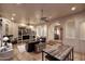 Spacious living room with built-in shelving, arched entryways, and hardwood flooring at 39241 N Boulder View Dr, Scottsdale, AZ 85262