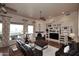 Cozy living room with a fireplace, large built-ins, hardwood floors, and expansive windows at 39241 N Boulder View Dr, Scottsdale, AZ 85262