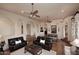 Open living room with a fireplace, archways, hardwood floors, and comfortable seating at 39241 N Boulder View Dr, Scottsdale, AZ 85262