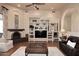 Bright living room featuring a fireplace, custom built-ins, and hardwood flooring at 39241 N Boulder View Dr, Scottsdale, AZ 85262