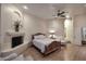 Relaxing main bedroom featuring hardwood floors, a fireplace, and a sitting area at 39241 N Boulder View Dr, Scottsdale, AZ 85262