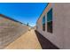 Low-maintenance backyard with gravel and a view of the home's exterior at 4080 W Goldmine Mountain Dr, San Tan Valley, AZ 85144