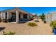 Large backyard with a covered patio, mature plantings, and gravel landscaping at 4080 W Goldmine Mountain Dr, San Tan Valley, AZ 85144