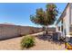 Landscaped backyard featuring beautiful trees and well-maintained gravel at 4080 W Goldmine Mountain Dr, San Tan Valley, AZ 85144