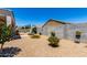 Spacious backyard with gravel landscaping and a privacy wall at 4080 W Goldmine Mountain Dr, San Tan Valley, AZ 85144