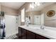 Bathroom featuring double vanity sinks and a walk-in shower at 4080 W Goldmine Mountain Dr, San Tan Valley, AZ 85144