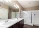Bathroom featuring double sinks, shower and a large mirror at 4080 W Goldmine Mountain Dr, San Tan Valley, AZ 85144