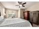Comfortable bedroom featuring carpet, ceiling fan, a bed and dressers at 4080 W Goldmine Mountain Dr, San Tan Valley, AZ 85144
