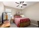 Bedroom with a bed, ceiling fan, and a side table at 4080 W Goldmine Mountain Dr, San Tan Valley, AZ 85144