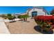 Beautiful desert home featuring tasteful xeriscaping and lush colorful bushes in the front yard at 4080 W Goldmine Mountain Dr, San Tan Valley, AZ 85144