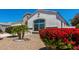Beautiful desert home featuring tasteful xeriscaping and lush colorful bushes in the front yard at 4080 W Goldmine Mountain Dr, San Tan Valley, AZ 85144