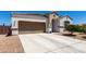 Attractive single-story house with a two-car garage and low-maintenance desert landscaping in a sunny setting at 4080 W Goldmine Mountain Dr, San Tan Valley, AZ 85144