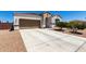 Attractive single-story house with a two-car garage and low-maintenance desert landscaping in a sunny setting at 4080 W Goldmine Mountain Dr, San Tan Valley, AZ 85144