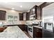 Bright kitchen with granite counters, stainless appliances, and natural light at 4080 W Goldmine Mountain Dr, San Tan Valley, AZ 85144