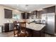 Kitchen island with granite countertops, stainless steel appliances, and barstool seating at 4080 W Goldmine Mountain Dr, San Tan Valley, AZ 85144