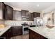 Well-equipped kitchen with granite countertops and stainless steel appliances at 4080 W Goldmine Mountain Dr, San Tan Valley, AZ 85144