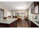 Open kitchen layout with granite countertops, stainless steel appliances, and dark wood cabinets at 4080 W Goldmine Mountain Dr, San Tan Valley, AZ 85144
