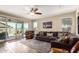 Comfortable living room with a ceiling fan, an area rug, and a sliding glass door to the outside patio at 4080 W Goldmine Mountain Dr, San Tan Valley, AZ 85144