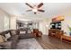 Comfortable living room featuring a ceiling fan, an area rug, and an open view to the kitchen area at 4080 W Goldmine Mountain Dr, San Tan Valley, AZ 85144