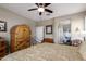 Comfortable bedroom featuring a decorative bed frame, a ceiling fan, and an ensuite bathroom at 4080 W Goldmine Mountain Dr, San Tan Valley, AZ 85144