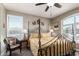 Bedroom with decorative iron bed frame, lamps, and window shutters at 4080 W Goldmine Mountain Dr, San Tan Valley, AZ 85144