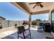 Covered patio with furniture and beautifully landscaped backyard at 4080 W Goldmine Mountain Dr, San Tan Valley, AZ 85144