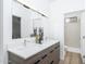 Modern bathroom with double vanity, large mirror with lighting, and a tiled walk-in shower at 4220 N 32Nd St # 31, Phoenix, AZ 85018