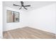 Empty bedroom features a ceiling fan, hardwood floors, and a large window with neighborhood views at 4220 N 32Nd St # 31, Phoenix, AZ 85018