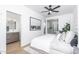 Bright bedroom featuring modern ceiling fan, en-suite bath, and a sleek black-and-white art print at 4220 N 32Nd St # 31, Phoenix, AZ 85018
