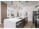 Spacious kitchen with stainless steel appliances, quartz counters, a central island, and modern pendant lighting fixtures at 4220 N 32Nd St # 31, Phoenix, AZ 85018