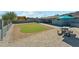 Backyard with a well-maintained patio area, artificial turf, and lush landscaping at 428 E Kachina Trl, Phoenix, AZ 85042